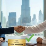 Emirati businessman and foreign investor shaking hands in Dubai office after receiving 100% ownership certificate.