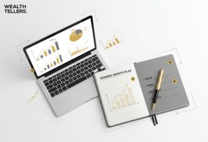 Open laptop showing charts and graphs beside a notebook titled “Business Growth Plan” with pen and strategy notes.