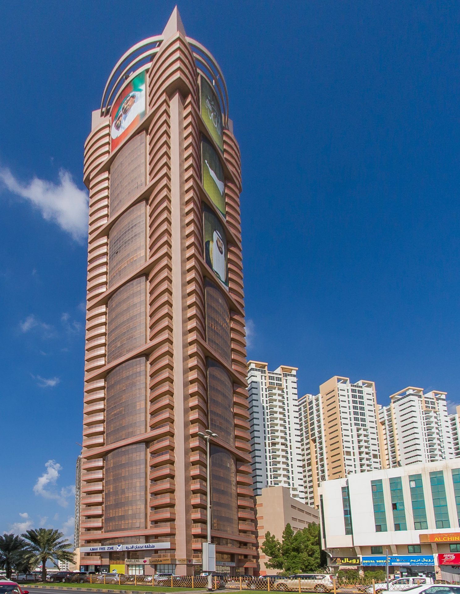 Modern UAE free zone business district scene with a creator filming content and reviewing paperwork for licensing