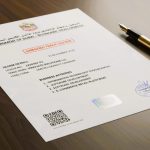 Amended UAE trade license document on a desk with official stamp, QR code, and a gold pen, representing updated business activity approval.