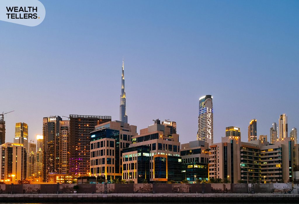 Dubai skyline at dusk with Burj Khalifa and modern buildings glowing, reflecting urban growth, stability, and economic strength in the UAE
